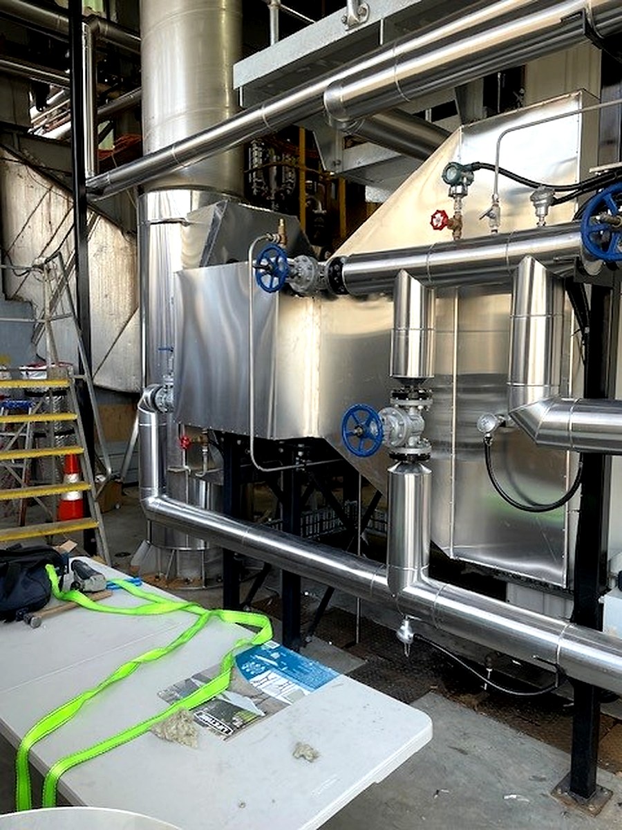Sheet metal cladding on insulated heat recovery vessel and associated pipework connections